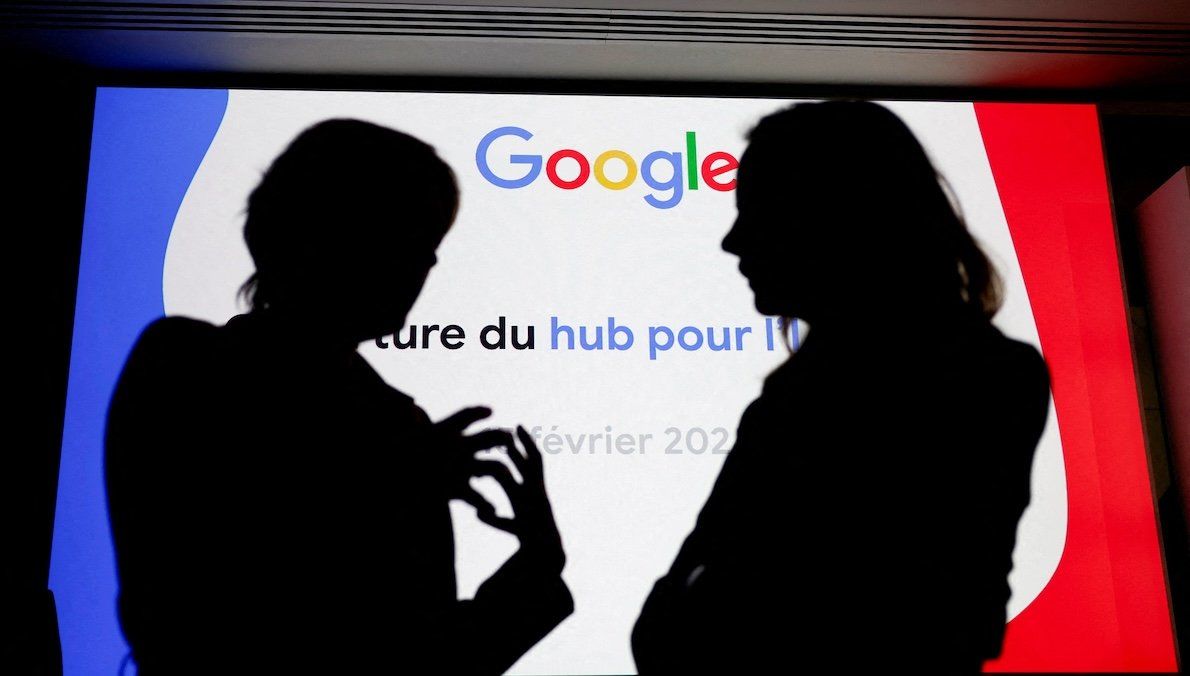 People silhouetted in front of a Google logo during the inauguration of a new hub in France dedicated to the artificial intelligence sector at the Google France headquarters in Paris, France. 