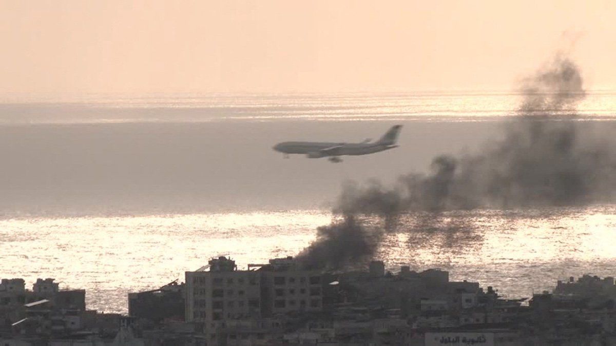 Plane descends through air strike smoke to land at airport in Beirut, Lebanon in this screengrab obtained on October 1, 2024. ​