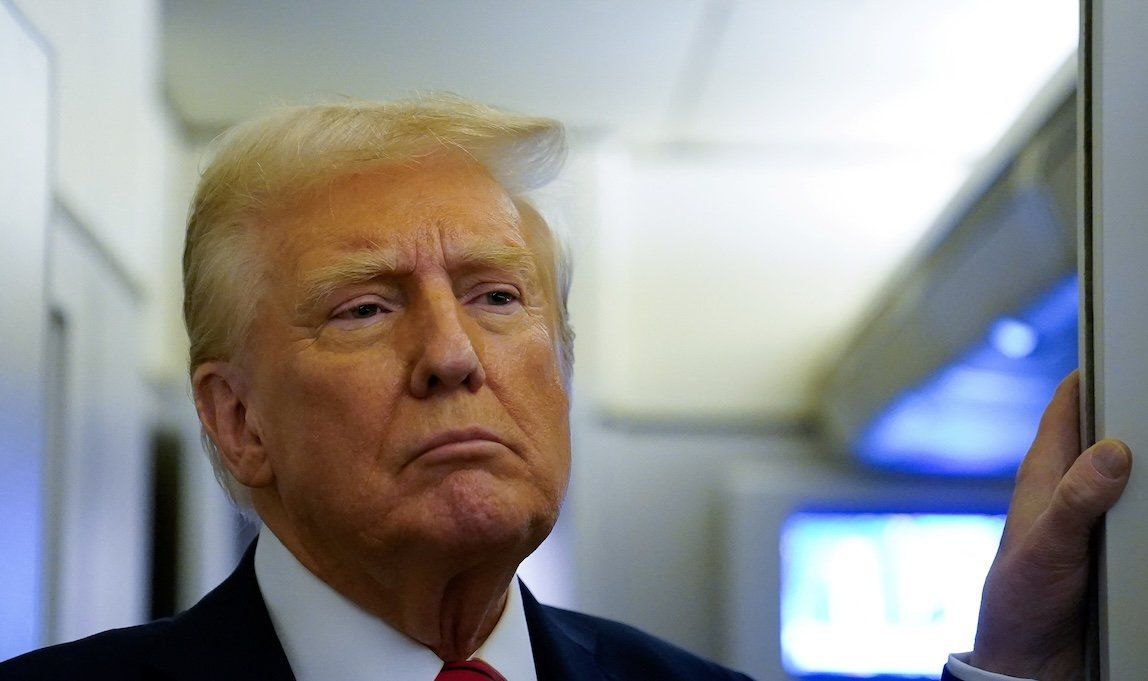 President Donald Trump speaks to reporters aboard Air Force One before arriving at Joint Base Andrews, Maryland, on Jan. 27, 2025. 