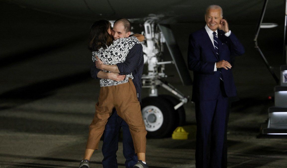 President Joe Biden looks on as Evan Gershkovich, who was released from detention in Russia, is greeted by his mother Ella Milman, upon his arrival at Joint Base Andrews in Maryland, on Aug. 1, 2024. 