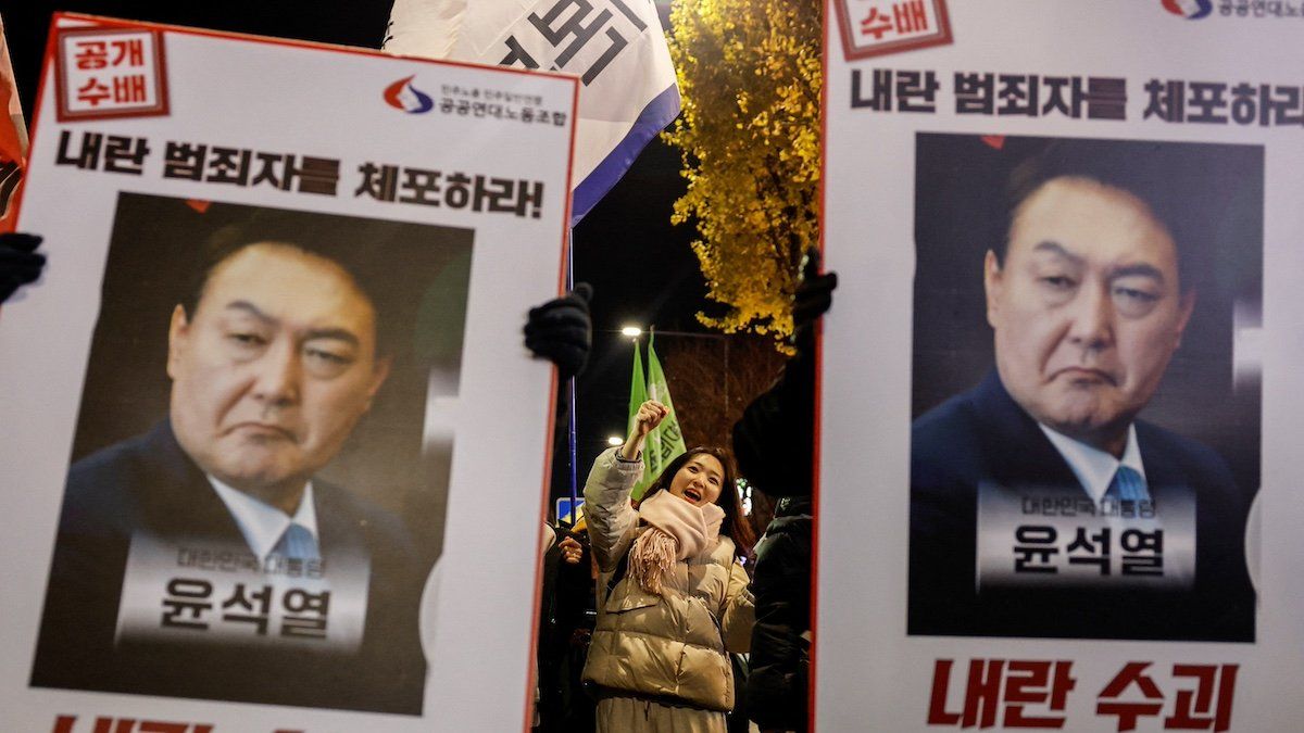 ​Protesters hold placards during a candlelight vigil to condemn South Korean President Yoon Suk Yeol's surprise declarations of the failed martial law and to call for his resignation in Seoul, South Korea, December 5, 2024. 