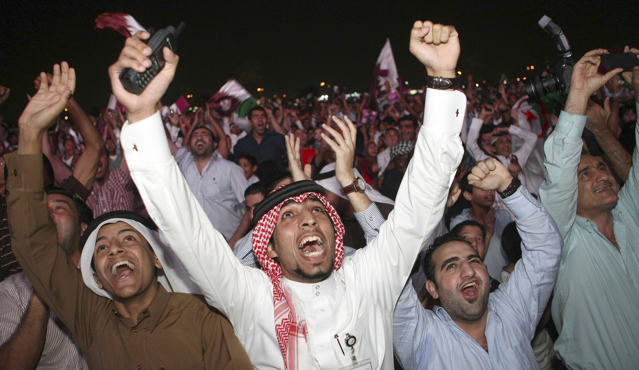 Qatari fans celebrate after the announcement that Qatar will host the 2022 World Cup