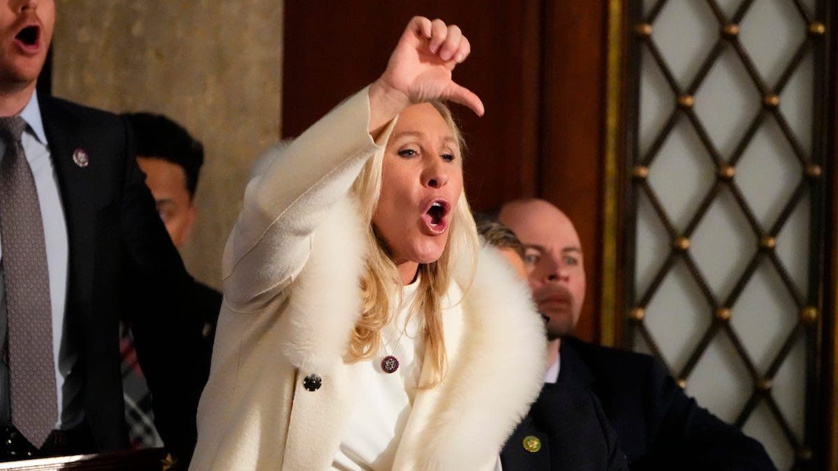 ​Rep. Marjorie Taylor Greene, R-GA, yells as President Joe Biden speaks during the State of the Union address from the House chamber of the US Capitol in Washington.