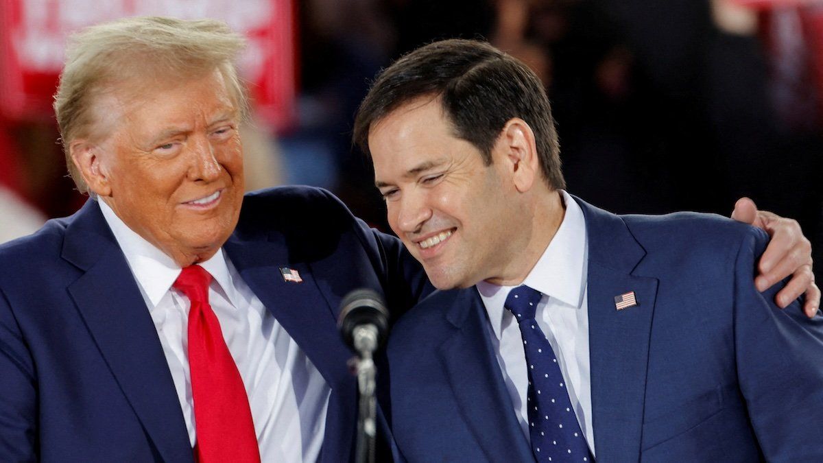 Republican presidential nominee and former U.S. President Donald Trump and Senator Marco Rubio (R-FL) react during a campaign event at Dorton Arena, in Raleigh, North Carolina, U.S. November 4, 2024.