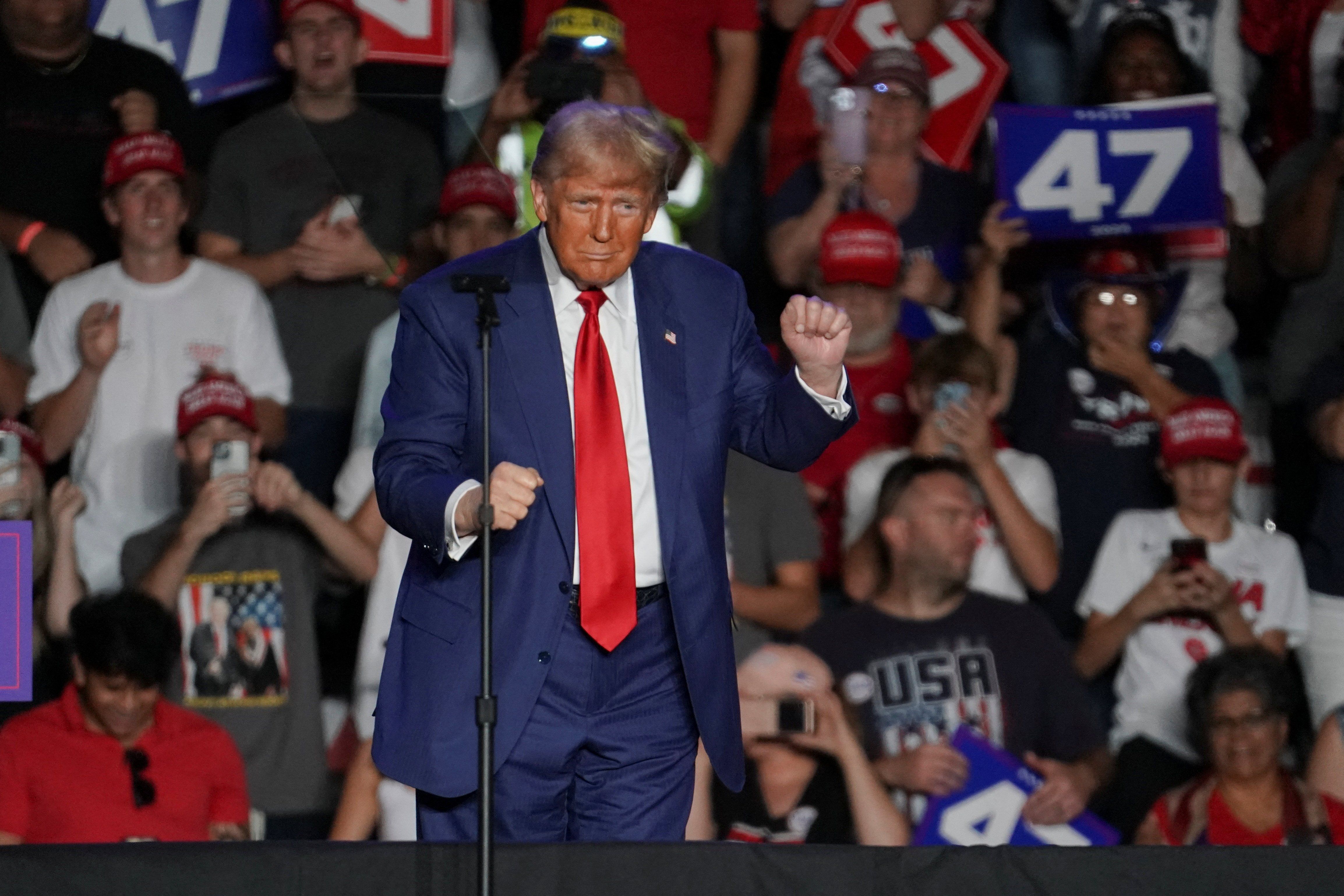 ​Republican presidential nominee and former U.S. President Donald Trump dances during a rally at Mullett Arena in Tempe, Arizona, U.S. October 24, 2024. 