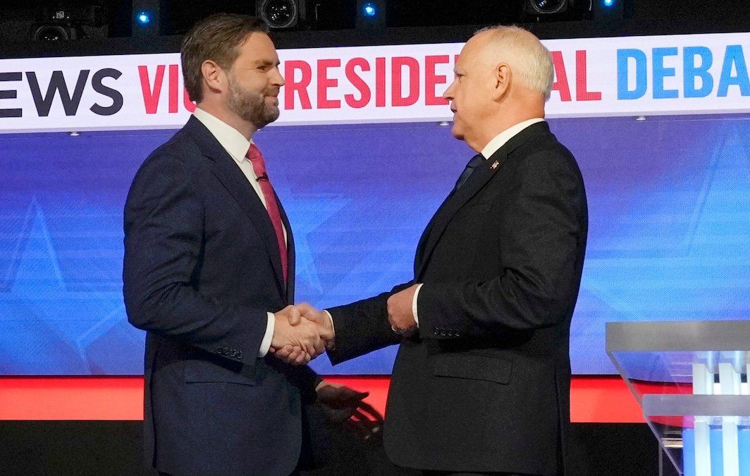 ​Republican Sen. JD Vance and Democrat Gov. Tim Walz greet each other before they square off during the CBS News vice presidential debate in New York City on Oct. 1, 2024.