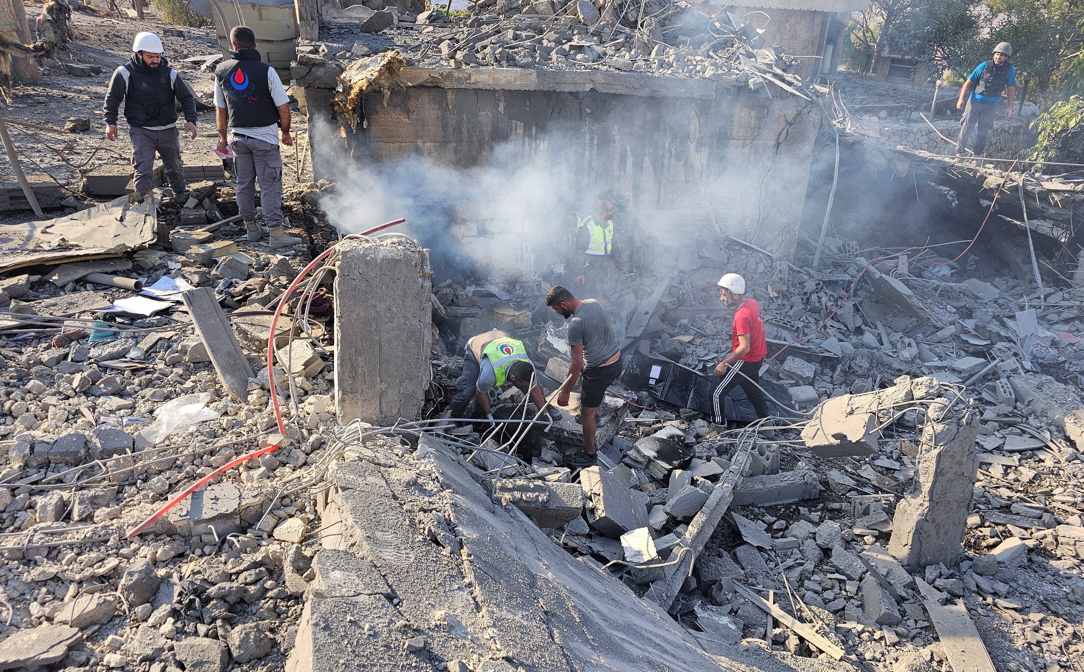 ​Rescuers work at a site damaged in the aftermath of an Israeli strike in Sohmor, in Lebanon's Bekaa Valley, October 30, 2024. 