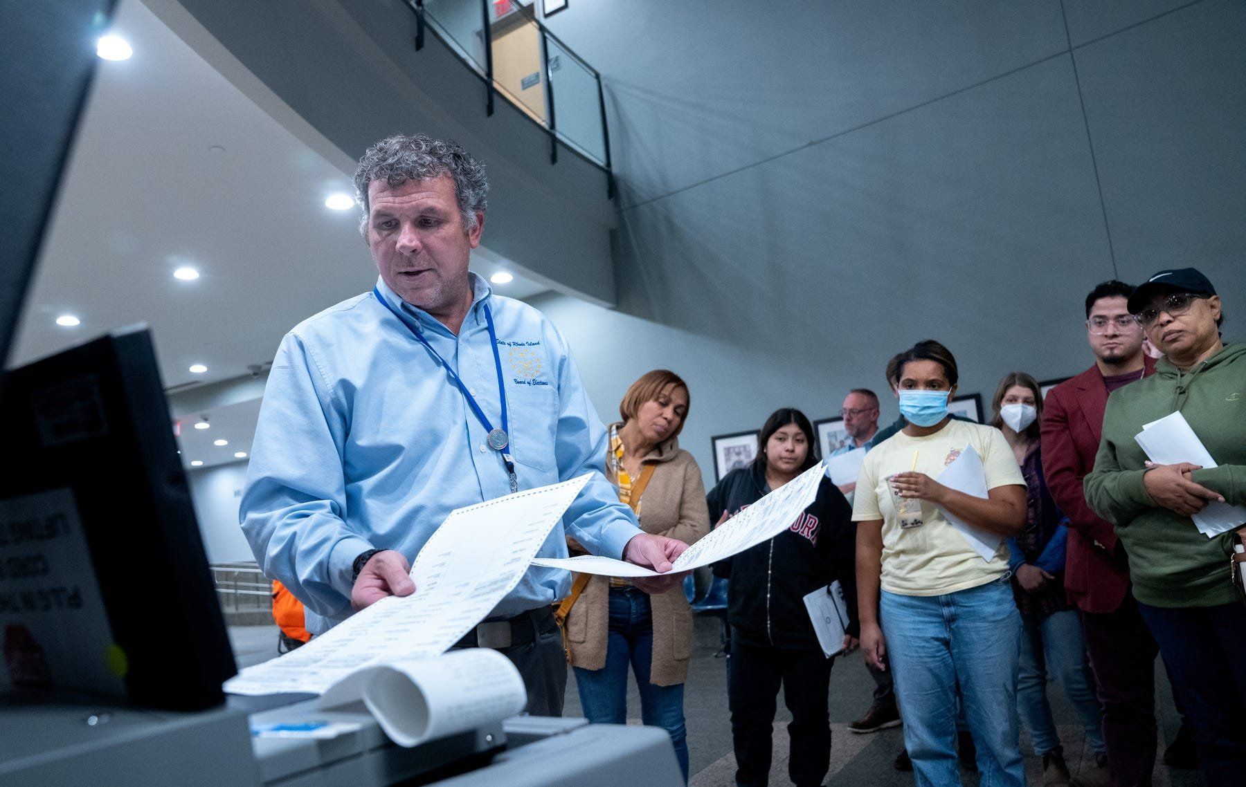 Robert Quinn, a planning and programming specialist at the state Board of Elections, shows poll supervisors the proper way to insert ballots in voting machines during a training session at the Providence Public Safety Complex.