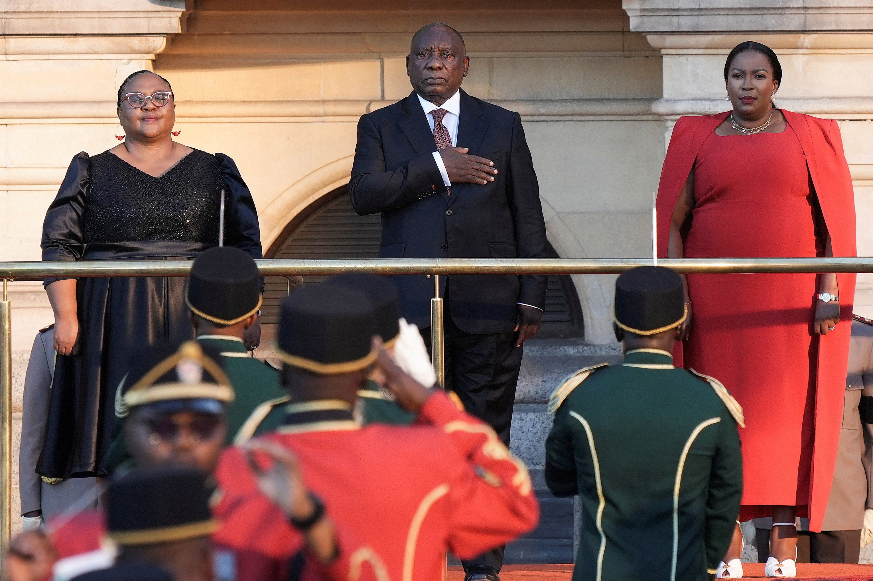 ​South African president Cyril Ramaphosa takes the national salute below a statue of former president Nelson Mandela at the Cape Town City Hall, ahead of his State Of The Nation (SONA) address in Cape Town, South Africa February 6, 2025.