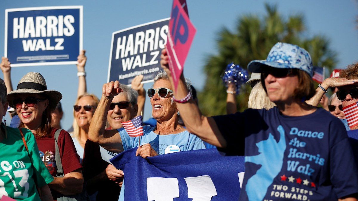 Supporters of Democratic presidential nominee and U.S. Vice President Kamala Harris cheer before the start of the golf cart rally in the retirement community of The Villages, Florida U.S. October, 14, 2024. 