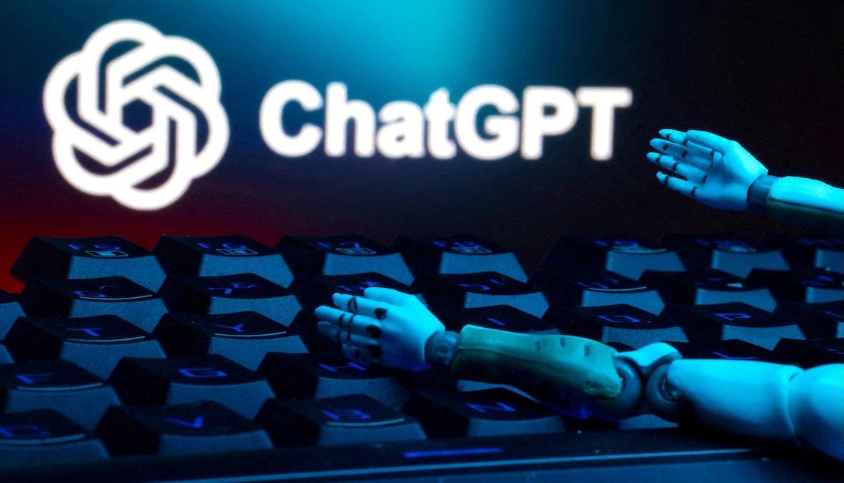 The ChatGPT logo, a keyboard, and robot hands are seen in this illustration. 