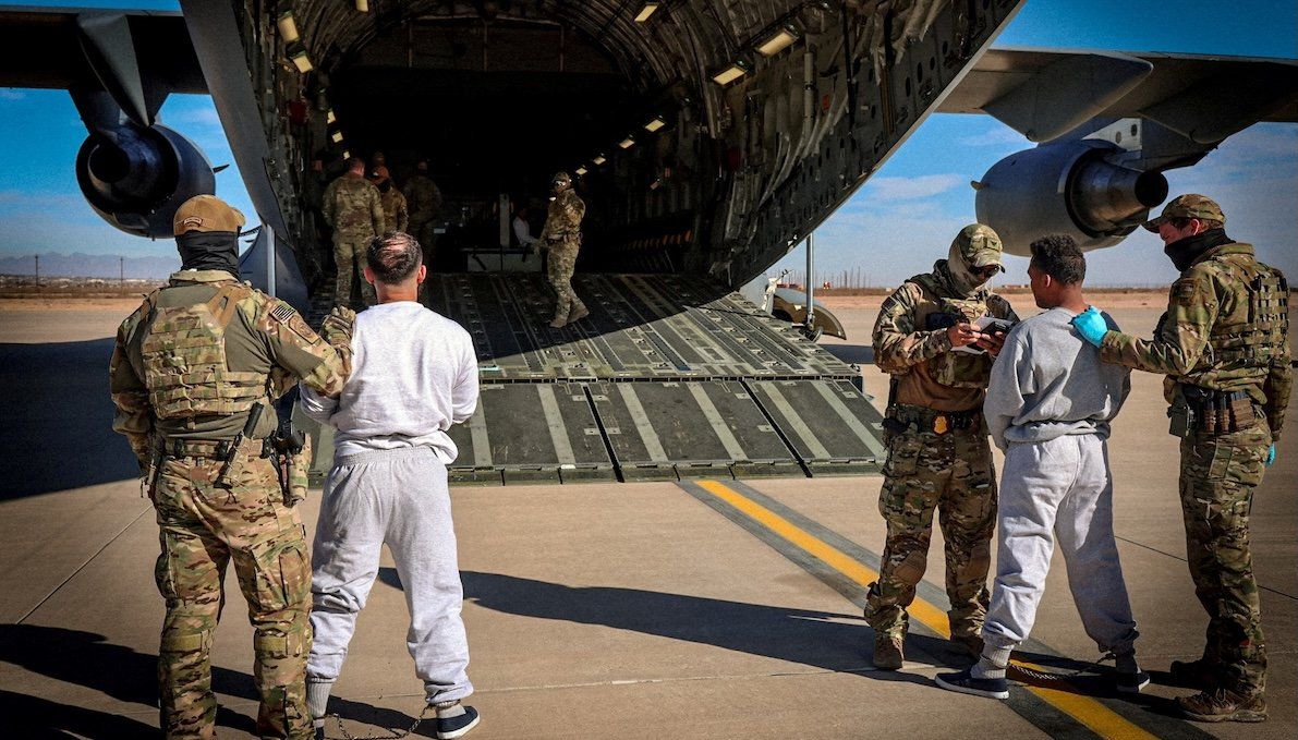 The first U.S. military aircraft to carry detained migrants to a detention facility at Guantánamo Bay, who Department of Homeland Security spokesperson Tricia McLaughlin called "highly dangerous criminal aliens," is boarded from an unspecified location on Feb. 4, 2025. 