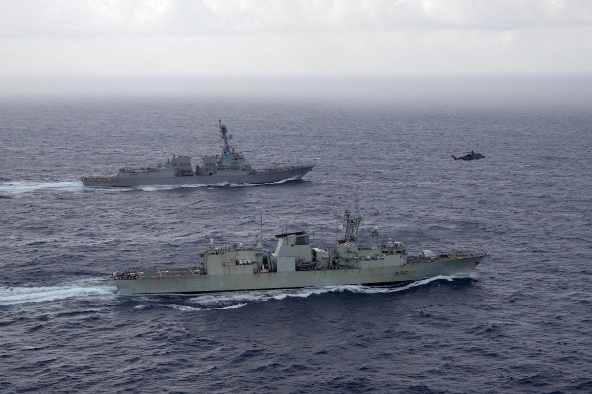 U.S. Navy guided-missile destroyer USS Chung-Hoon sails alongside the Royal Canadian Navy frigate HMCS Montreal during Surface Action Group operations as a part of exercise “Noble Wolverine" in the South China Sea May 30, 2023.