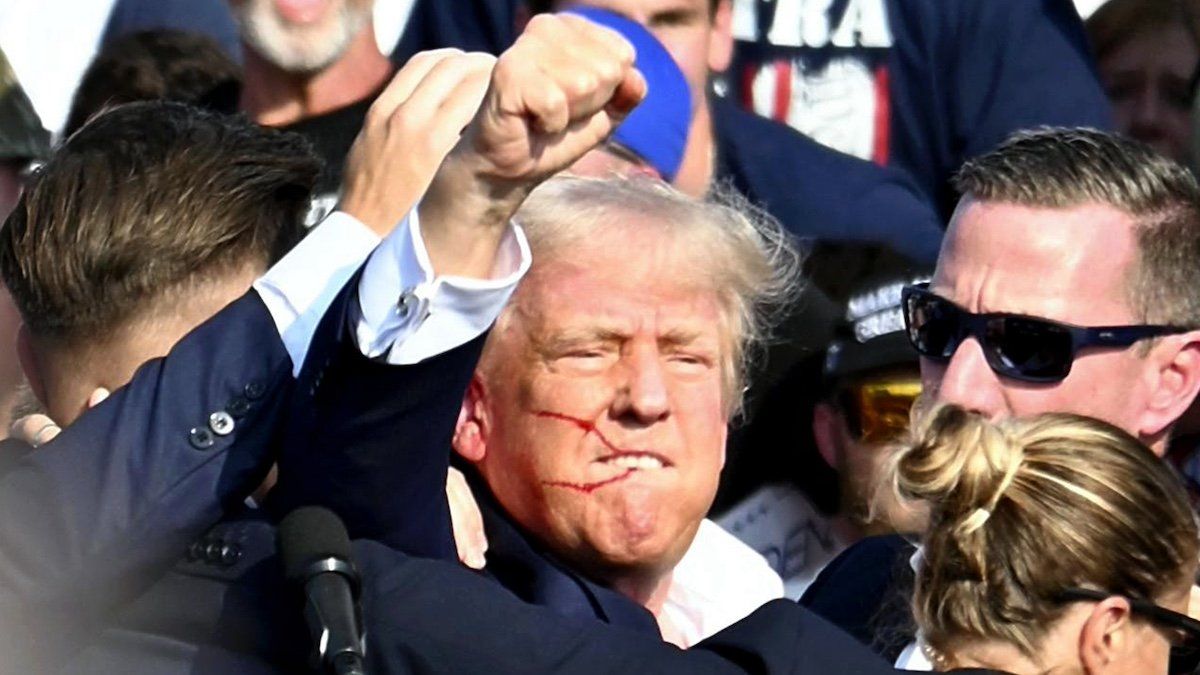 U. S. Republican presidential candidate former President Donald Trump is surrounded by U.S. Secret Service agents in Butler, Pennsylvania on July 13, 2024.