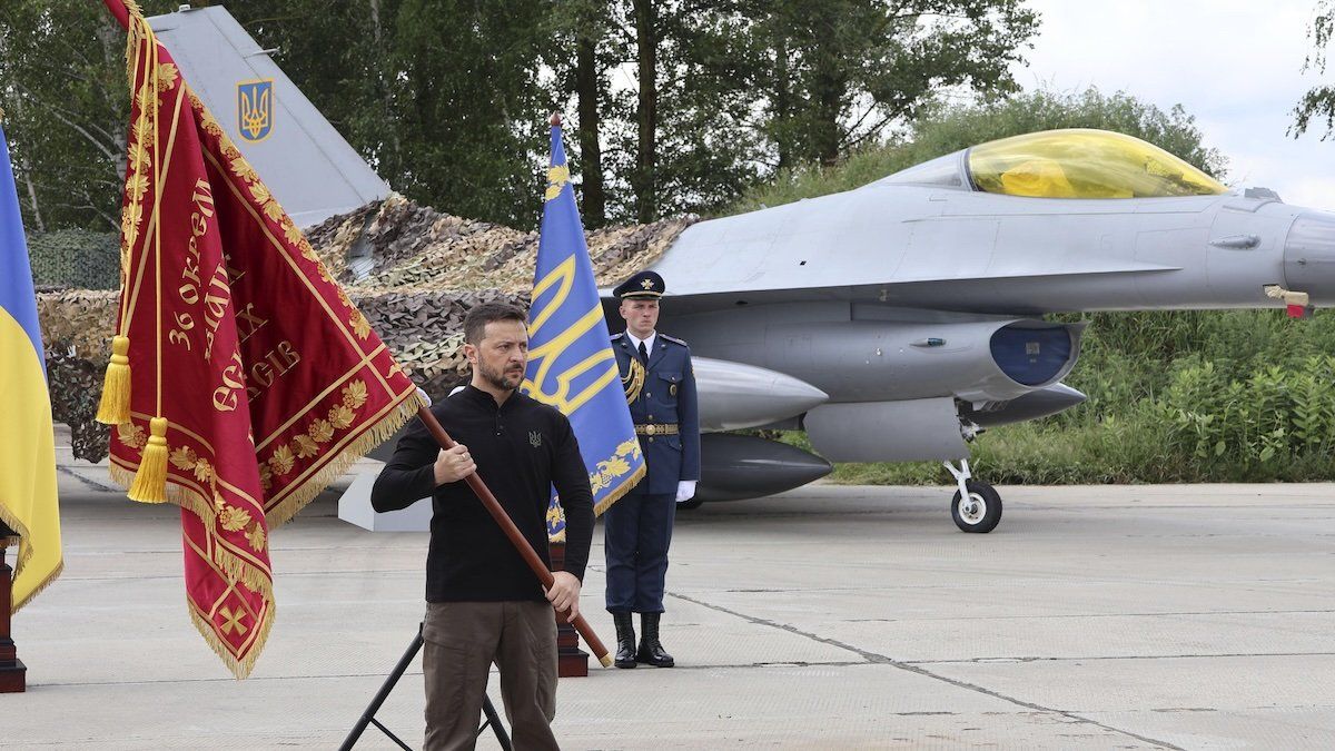 Ukrainian President Volodymyr Zelensky stands near newly arrived F-16 fighter jets at a location not disclosed for security reasons on Aug. 4, 2024. 