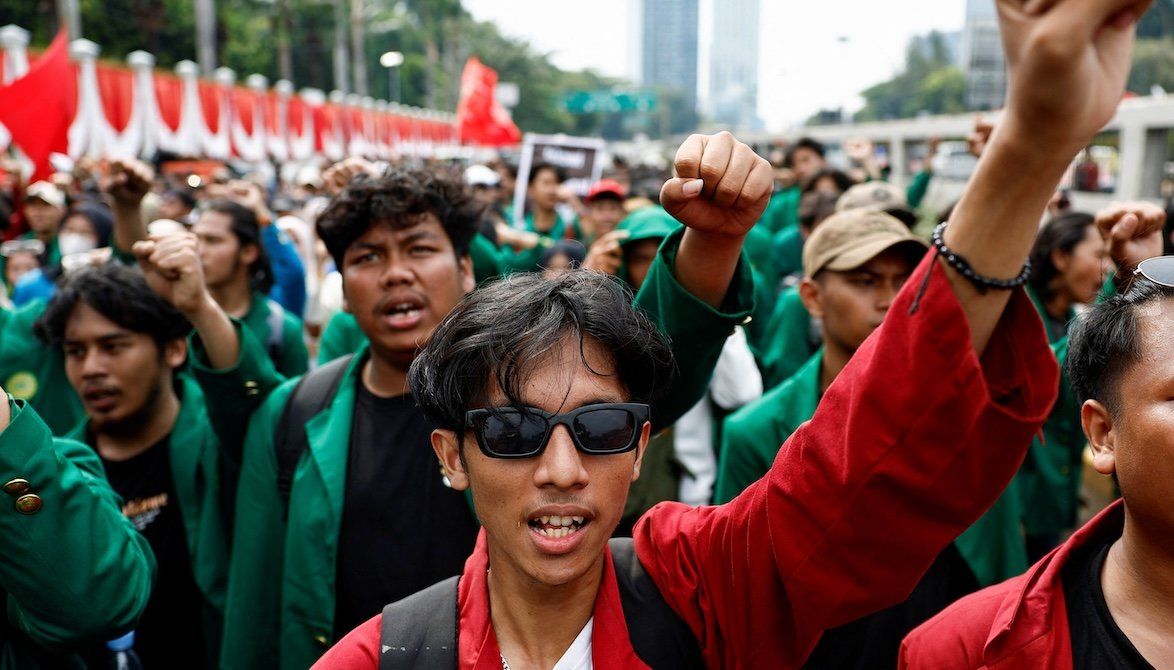 ​University students gesture as they shout slogans during a protest against planned controversial revisions to election law outside the Indonesian Parliament building in Jakarta, Indonesia, on Aug. 22, 2024. 