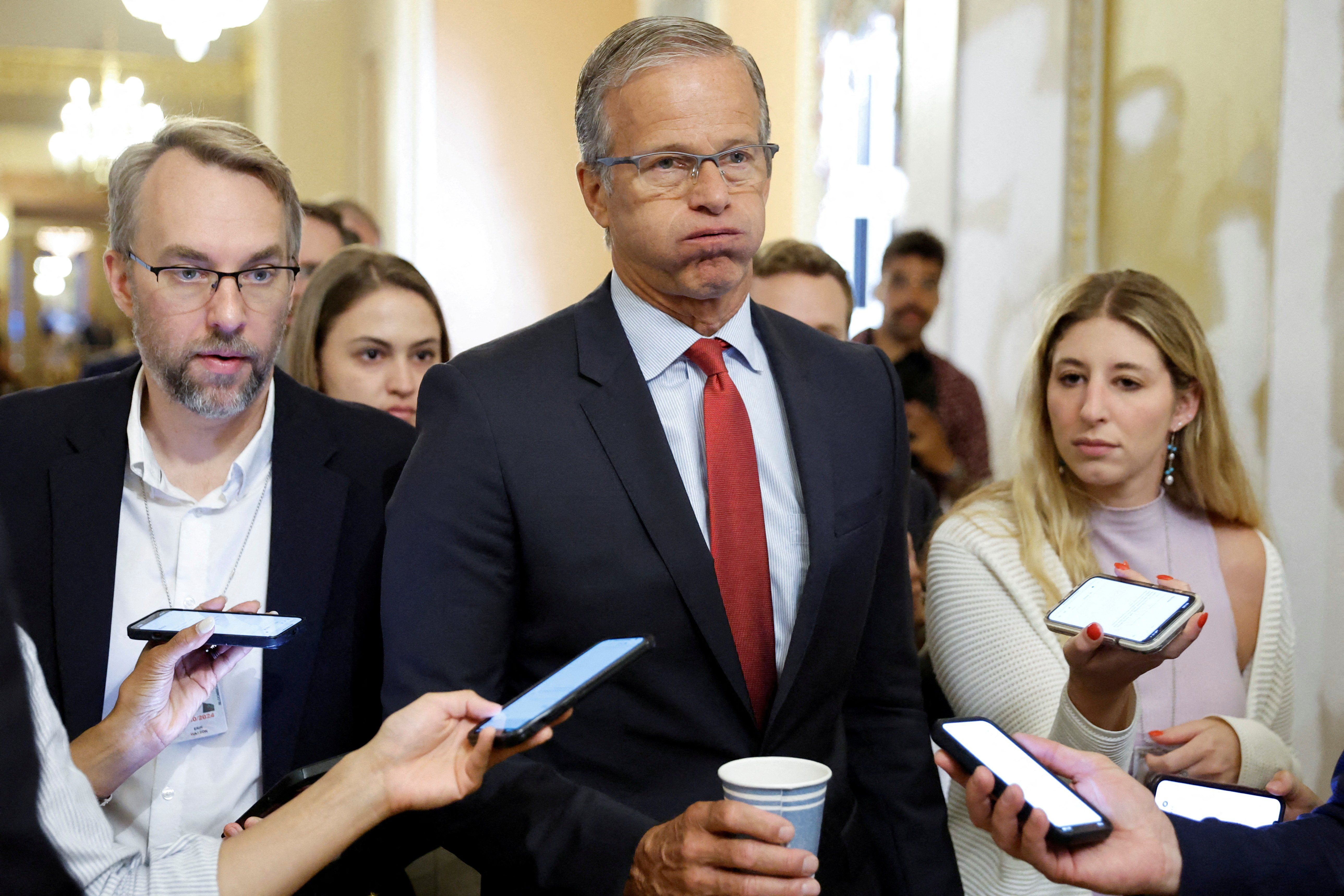 US Sen. John Thune (R-SD) talks to reporters about wrangling over the upcoming vote on debt ceiling legislation to avoid a historic default at the US Capitol in Washington, DC.