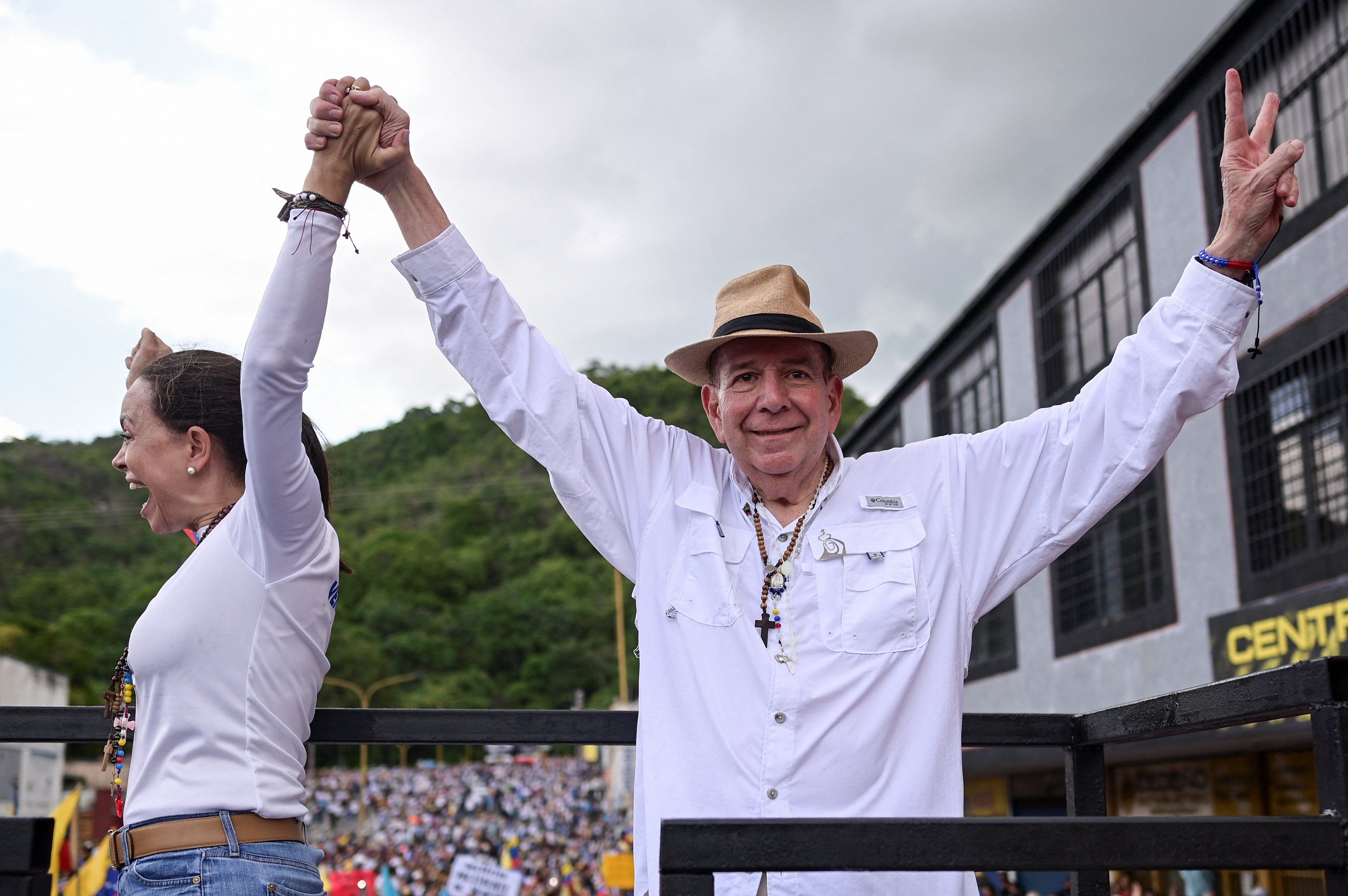 Venezuelan opposition presidential candidate Edmundo Gonzalez and Venezuelan opposition leader Maria Corina Machado greet supporters during a campaign rally for the presidential election in Valencia, Carabobo State, Venezuela, July 13, 2024. 