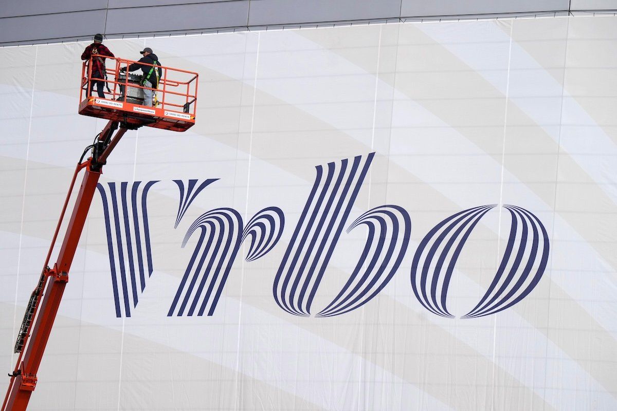 ​Vrbo signage on the exterior of a stadium. 