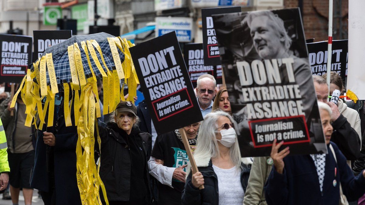 LONDON, UNITED KINGDOM - OCTOBER 23, 2021: Demonstrators march through central London in solidarity with Julian Assange ahead of next week's US extradition appeal hearing at the High Court on October 23, 2021 in London, England.