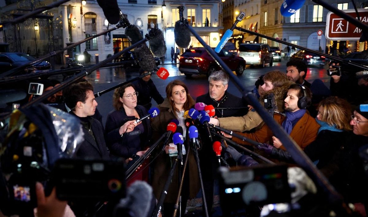 ​Marine Tondelier, of Les Ecologistes party, talks to journalists next to colleagues as they leave a meeting at the Elysee Palace in Paris on Dec. 10. They had met with the French president as part of consultations aimed at appointing a new prime minister.