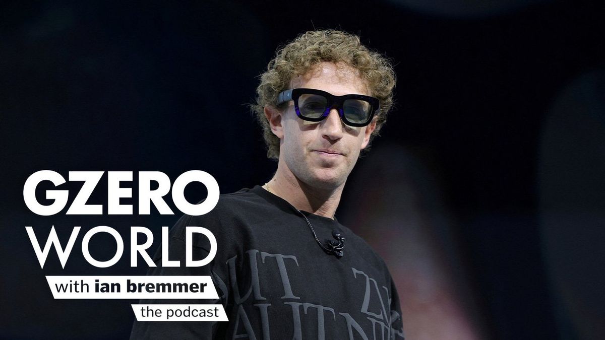 Mark Zuckerberg, CEO of Meta, stands on stage wearing black augmented reality glasses and a graphic sweater, with text art reading "GZERO World with Ian Bremmer – the podcast."