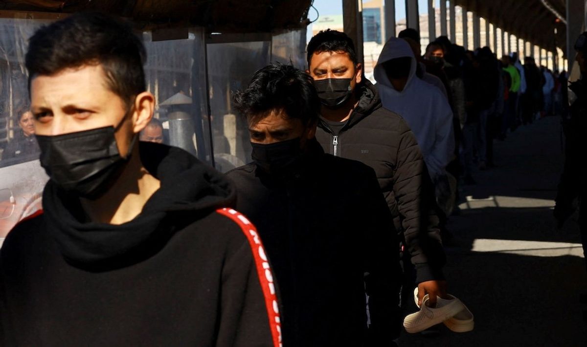 ​Migrants line up to leave the United States for Mexico after being deported across the Paso del Norte international border bridge after President Donald Trump promised mass deportation operation, as seen from Ciudad Juarez, Mexico, on Jan. 23, 2025. 