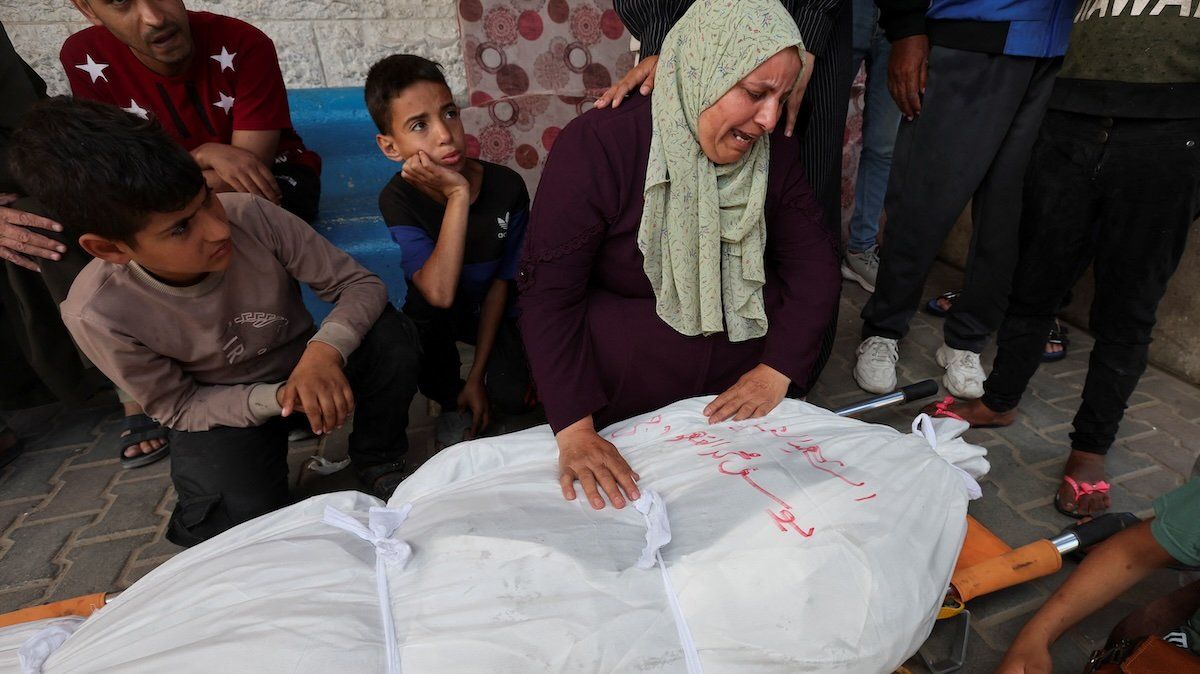 Mourners react next to the body of a Palestinian killed in Israeli strikes, amid the ongoing conflict between Israel and Hamas, at Al-Aqsa hospital, in Deir Al-Balah, in the central Gaza Strip, May 12, 2024.
