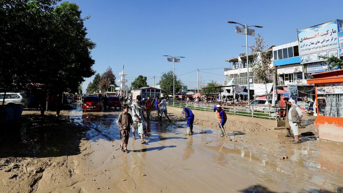 Municipality workers remove debris from the streets after flooding in Sheikh Jalal district, Baghlan province, Afghanistan May 12, 2024. 