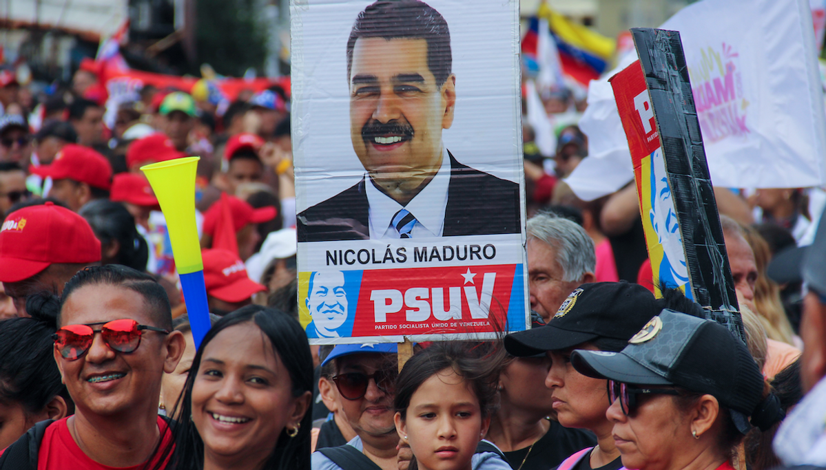 ​People are carrying a banner with political phrases during a rally in support of Nicolas Maduro's campaign in San Cristobal, Venezuela, on July 10, 2024.