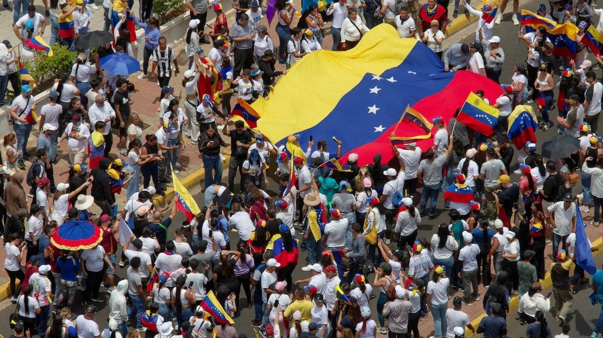 People carry Venezuela's national flag to protest the election results that awarded Venezuela's President Nicolas Maduro a third term, in Maracaibo, Venezuela, on July 30, 2024. 