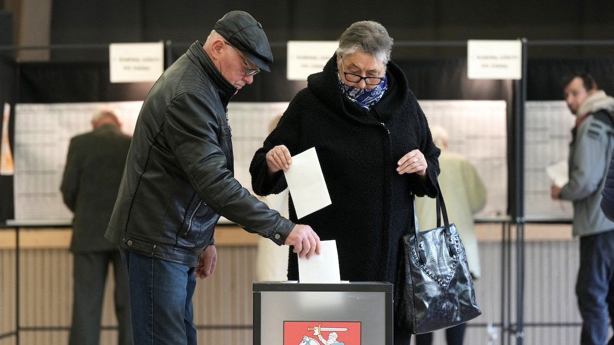 ​People cast their votes during general election in Utena, Lithuania October 13, 2024. 