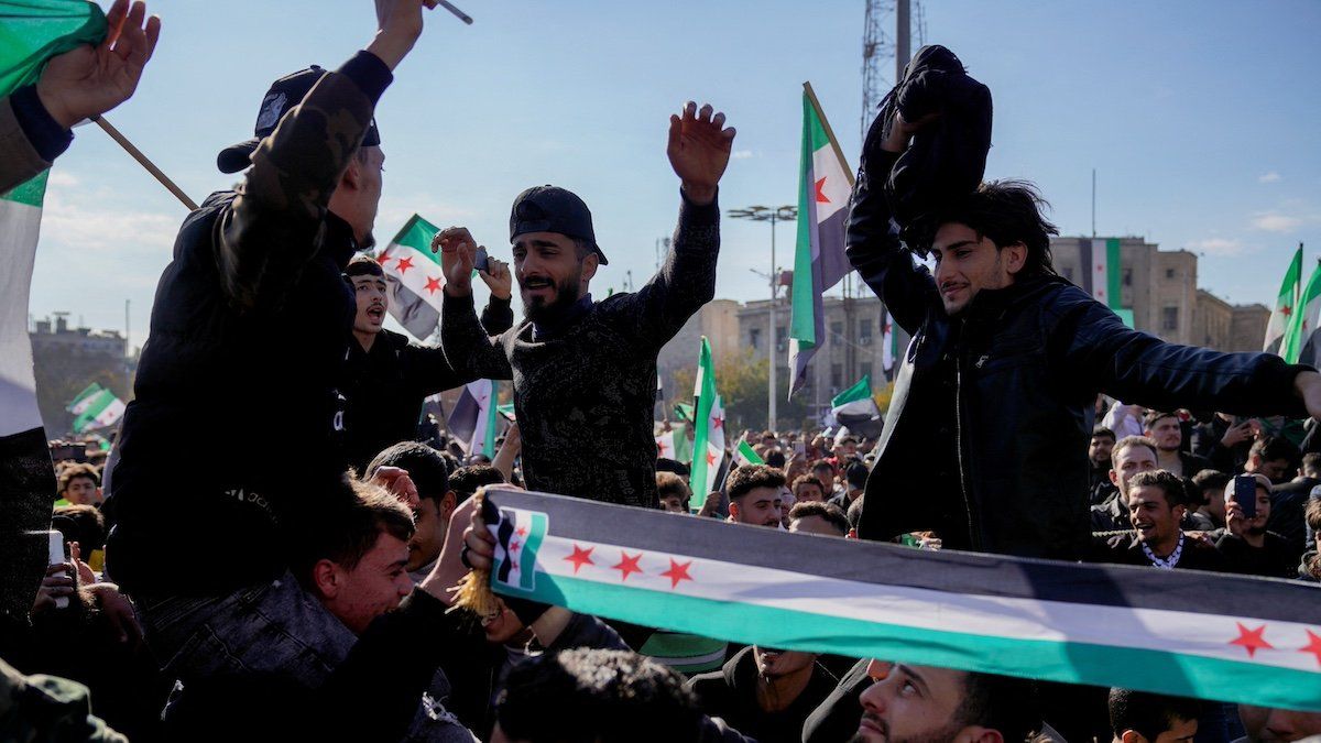 ​People celebrate after fighters of the ruling Syrian body ousted Syria's Bashar al-Assad, in Aleppo, Syria, December 13, 2024. 