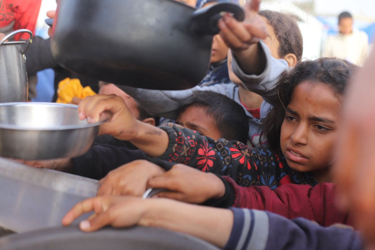 ​People gather to get food relief in the southern Gaza Strip city of Rafah, on March 17, 2024.