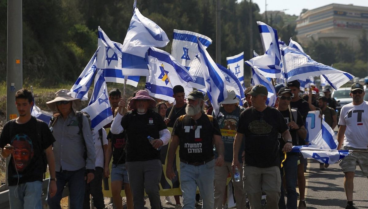 ​People march towards Jerusalem during a rally against the government and Israeli Prime Minister Benjamin Netanyahu to demand the release of all hostages from Gaza, on March 18, 2025. 