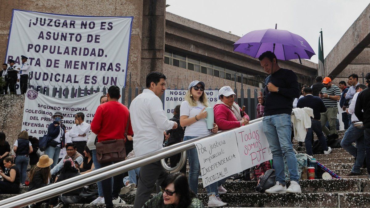 ​People stand outside the building of the Federal Judiciary Council as Mexico's judicial workers launched an indefinite nationwide strike ahead of votes by lawmakers on overhauling the country's judiciary, including moving to the popular election of judges, in Mexico City, Mexico August 19, 2024. 