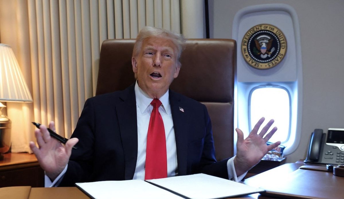 President Donald Trump speaks to reporters aboard Air Force One en route to New Orleans to attend the Super Bowl, on Feb. 9, 2025. 