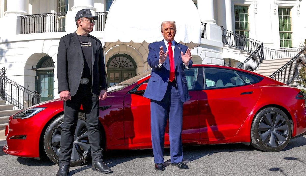 President Donald Trump talks to the media next to Tesla CEO Elon Musk, with a Tesla car in the background, at the White House on March 11, 2025. 