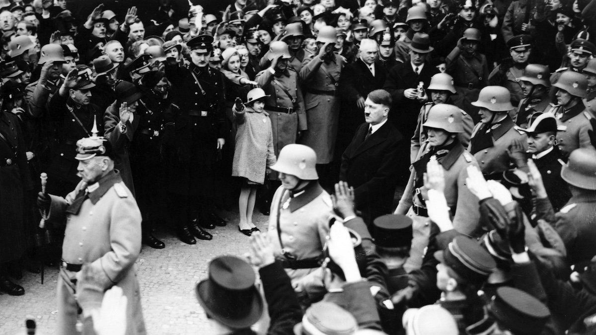​Reich President Paul von Hindenburg and Reich Chancellor Adolf Hitler are greeted by the people with the Nazi salute on the occasion of the Day of Commemoration of Heroes on 25 February 1934. 