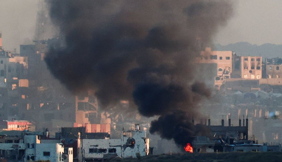 ​Smoke rises from a burning building in North Gaza, as seen from the Israel-Gaza border, March 23, 2025.