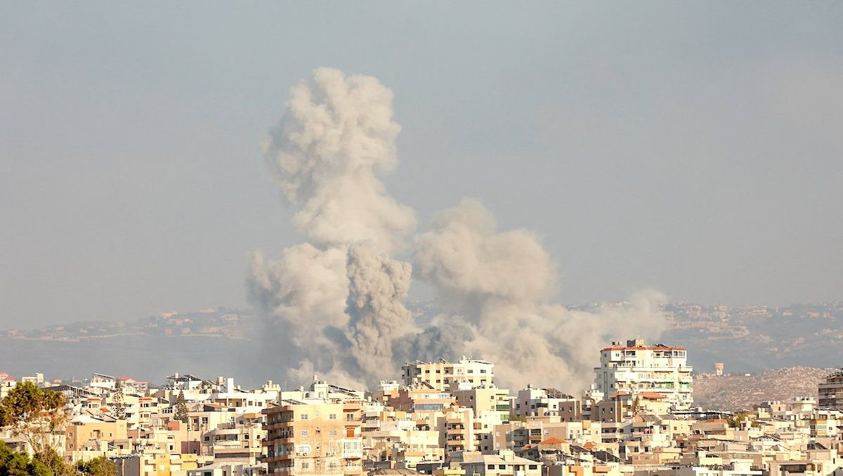 ​Smokes rise amid ongoing cross-border hostilities between Hezbollah and Israeli forces, in Tyre, southern Lebanon on Sept. 23, 2024. 