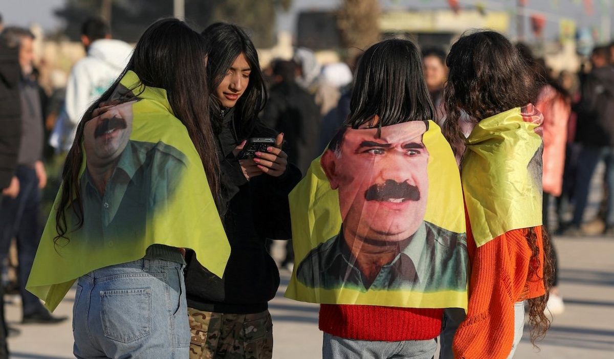 ​Syrian Kurds gather with flags