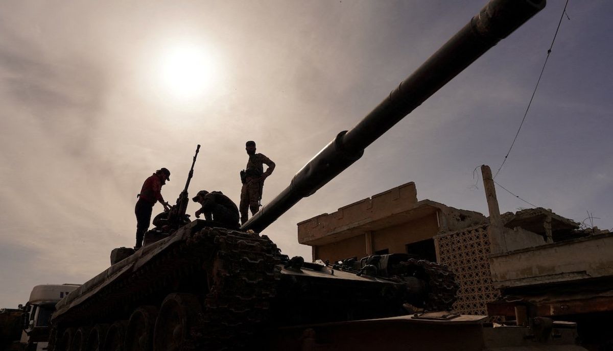 ​Syrian troops sit atop a tank as they head toward the Syrian-Lebanese border following clashes with Lebanese soldiers and armed groups, in Qusayr, Syria, March 17, 2025.