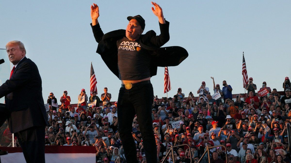 Tesla CEO and X owner Elon Musk reacts next to Republican presidential nominee and former U.S. president Donald Trump during a campaign rally, at the site of the July assassination attempt against Trump, in Butler, Pennsylvania, U.S., October 5, 2024.