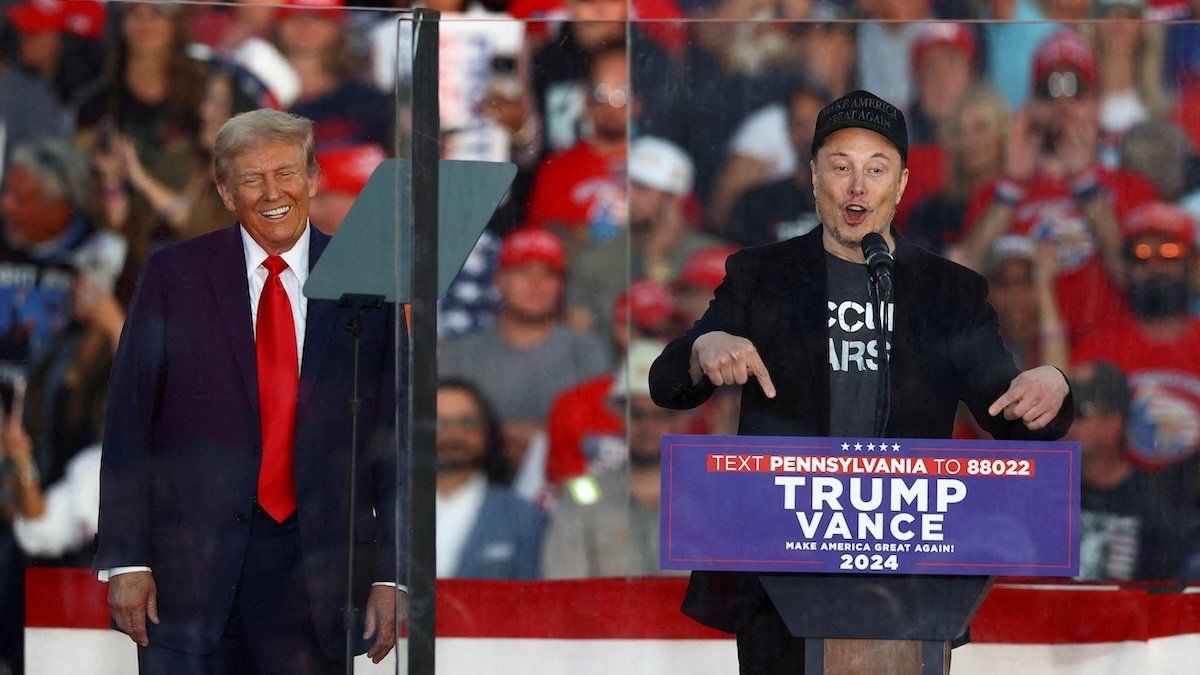 Tesla CEO and X owner Elon Musk speaks as Republican presidential nominee and former U.S. president Donald Trump reacts during a rally at the site of the July assassination attempt against Trump, in Butler, Pennsylvania, U.S., October 5, 2024. 