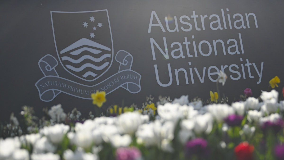 ​The logo of the Australian National University (ANU) is seen at the campus in Canberra, Wednesday, September 16, 2020. The Australian National University (ANU) says COVID-19 will force it to shed hundreds of jobs from its workforce. Estimates put the total job losses at 465, including 250 voluntary redundancies.