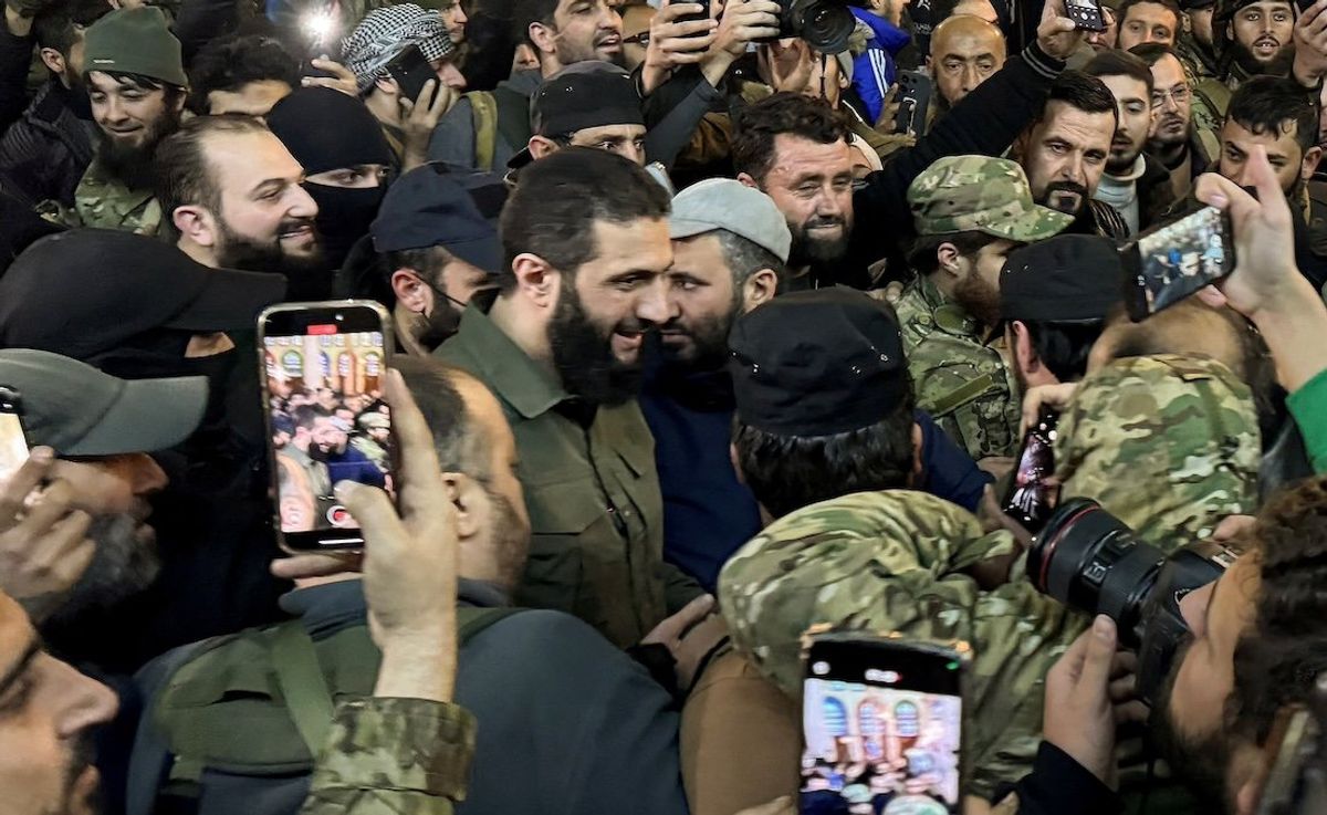 ​Top rebel commander Abu Mohammed al-Golani greets the crowd at Ummayad Mosque in Damascus after Syrian rebels announced that they have ousted President Bashar Assad, on Dec. 8, 2024. 