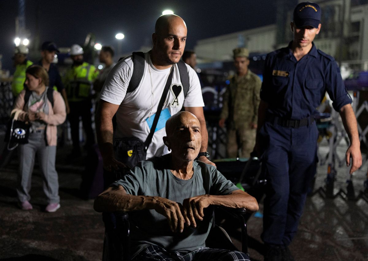 ​Turkish citizens disembark naval ship TCG Bayraktar carrying people evacuated from Lebanon upon their arrival at a port in Turkey's Mediterranean coastal province of Mersin, Turkey, October 10, 2024. 