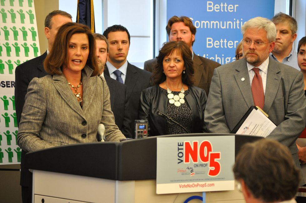 \u200bThen-Senator Gretchen Whitmer (L) speaks at a Vote No on Proposal 5 press conference at the Michigan Municipal League offices in Lansing, Oct. 9, 2012.