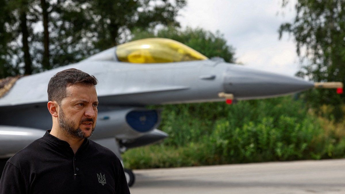 Ukraine's President Volodymyr Zelenskiy speaks to the media in a front of an F-16 fighting aircraft after marking the Day of the Ukrainian Air Forces, amid Russia's attack on Ukraine, in an undisclosed location, Ukraine August 4, 2024.